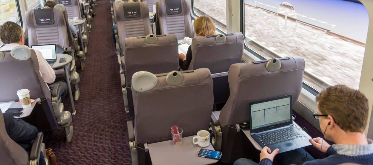 People working on laptops on Grand Central trains