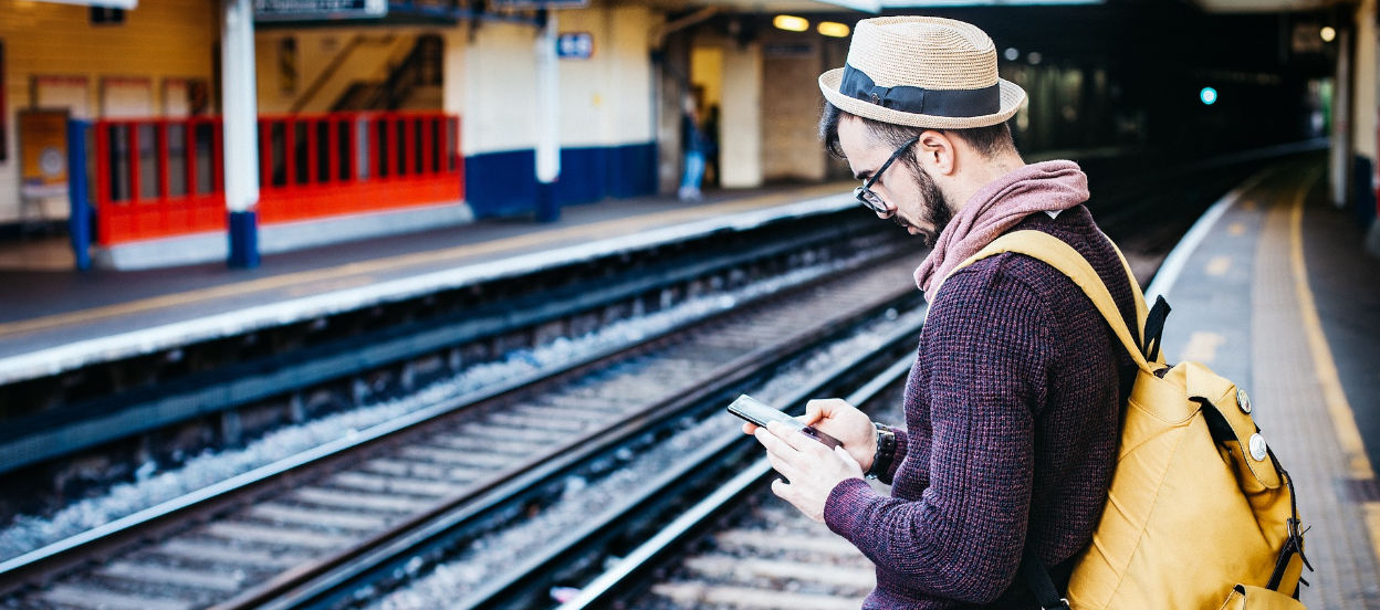 Man checking train times on Grand Central app