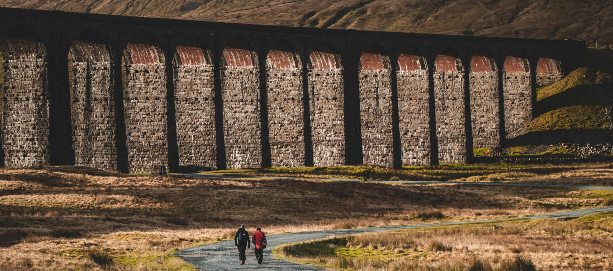 Walking below a viaduct in the Yorkshire Dales