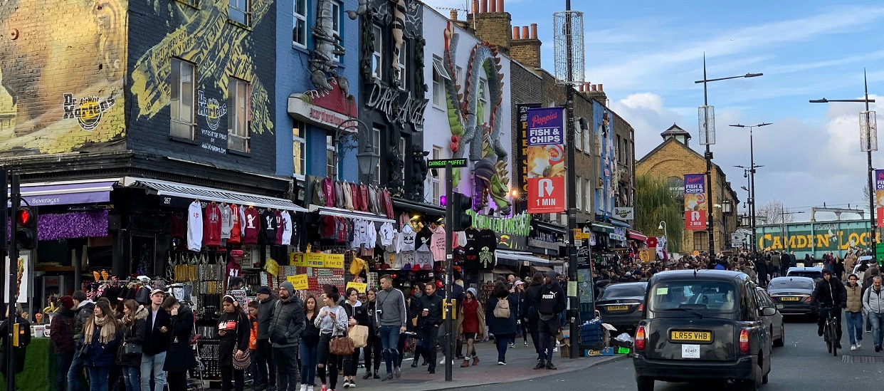 Vibrant vintage clothes shops in Camden with Camden Lock in background