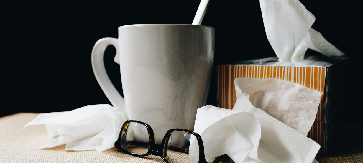 tissues and cup of tea signifying a cold/flu