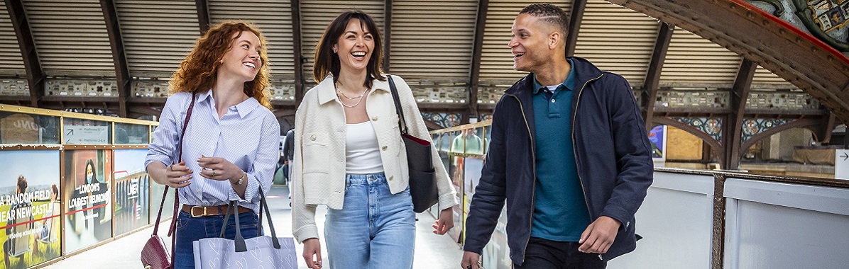 2 women and a man walking at York train station