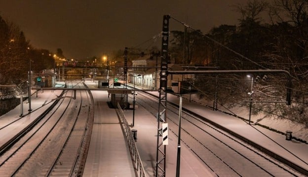train station and tracks covered in snow