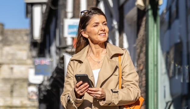 Lady holding her phone in York