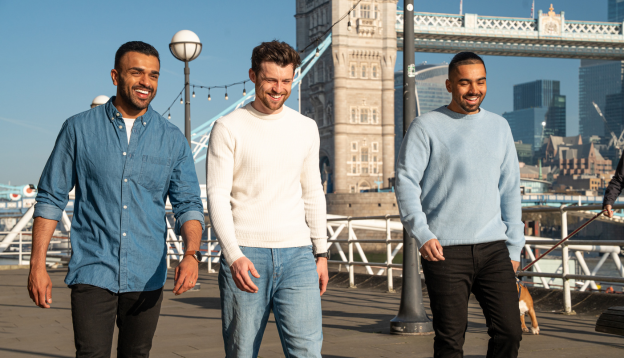 Three friends in London walking across London Bridge