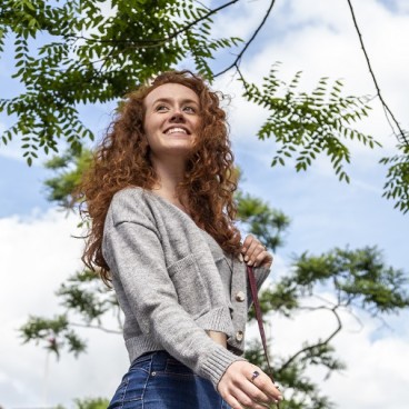 lady walking in front of King's Cross clock