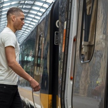man walking onto a Grand Central train 
